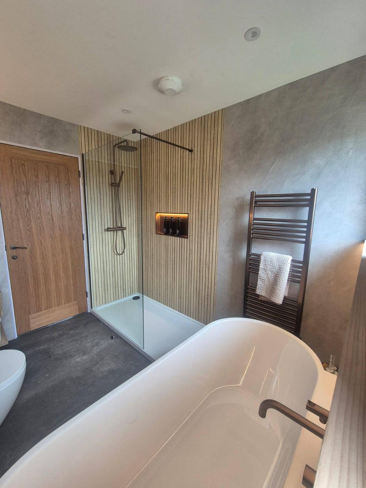 Luxury bathroom renovation with freestanding bath and walk-in rainfall shower