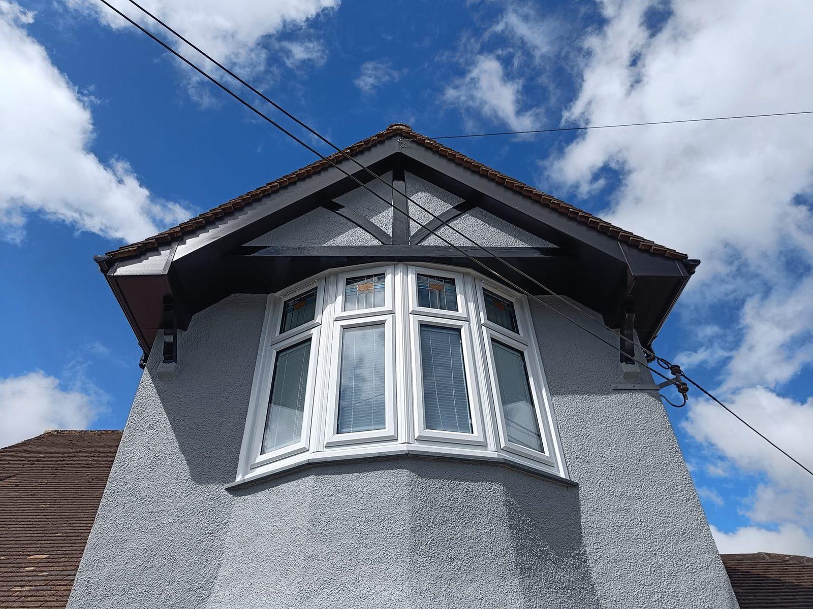 Restored rendered gable with mock-Tudor detailing and a bay window