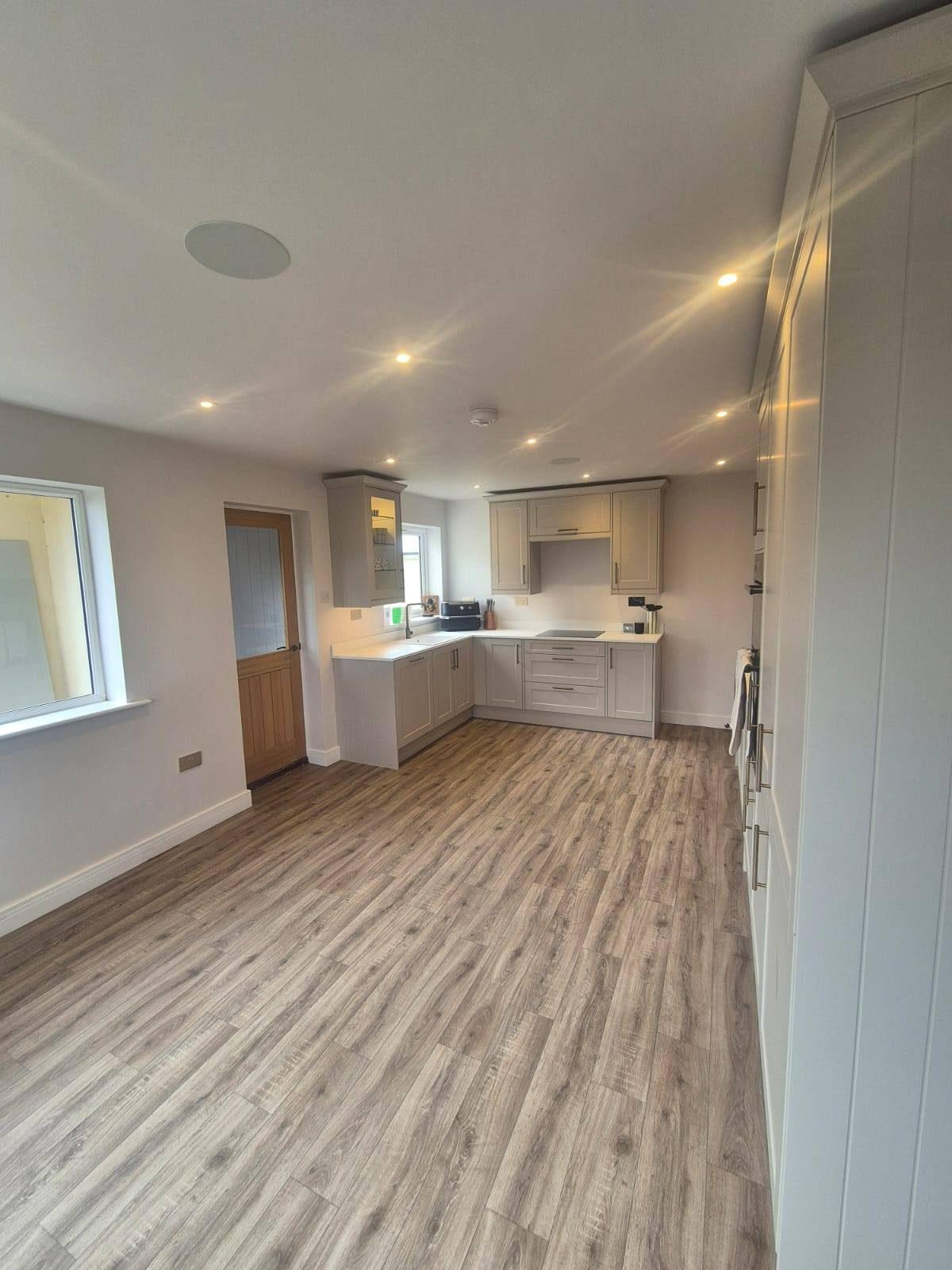 Open-plan kitchen and living room with cream units