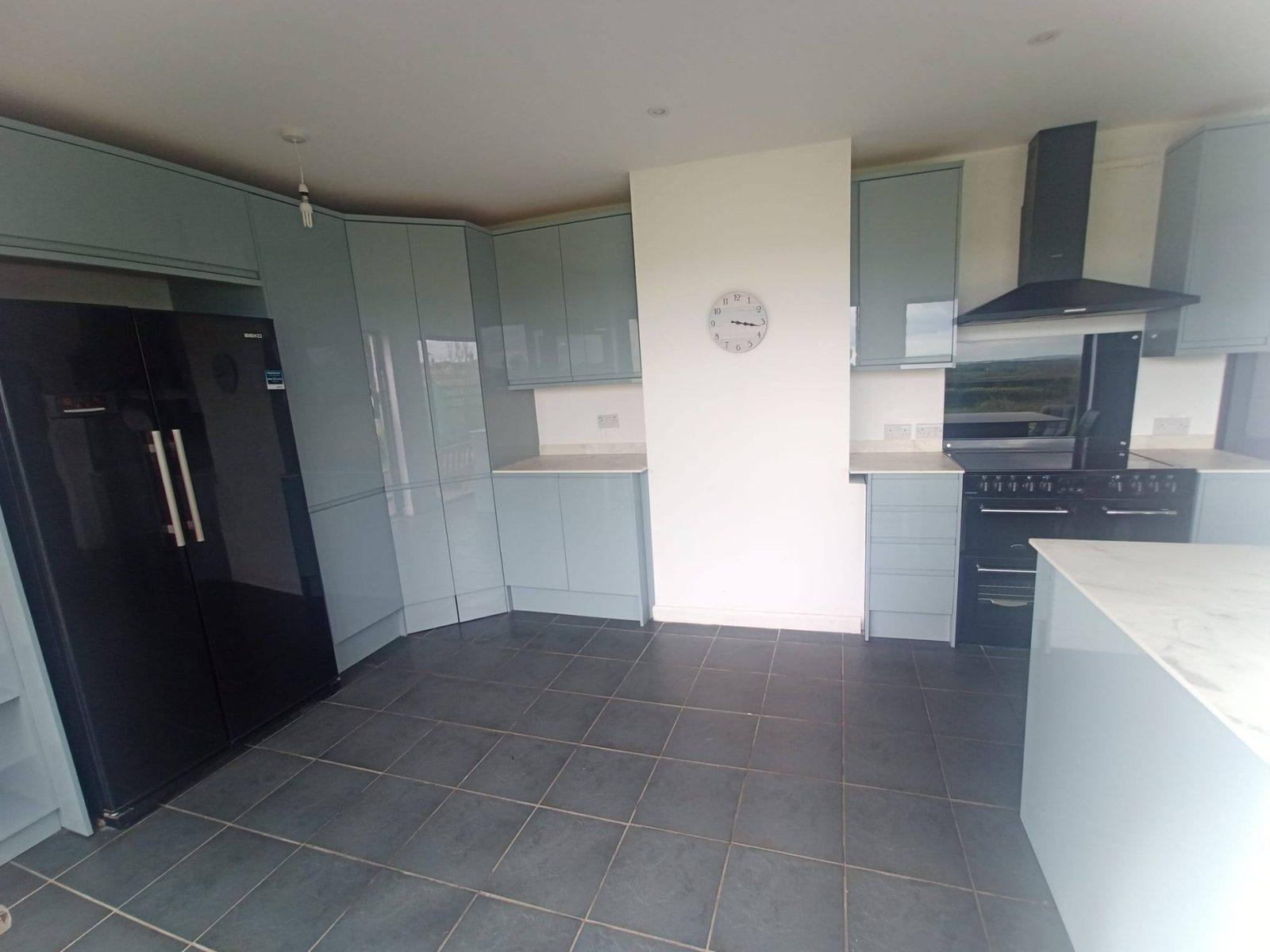 Fitted kitchen with sage units and marble worktops