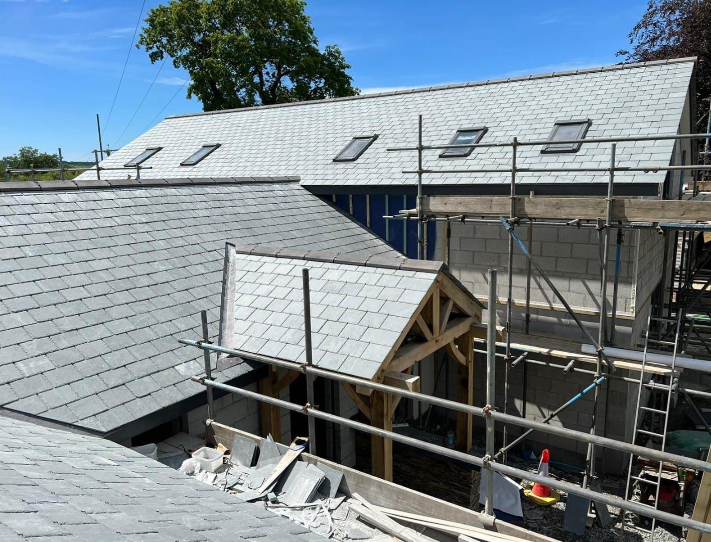 Slate-roofed barn-style new build with oak-framed porch