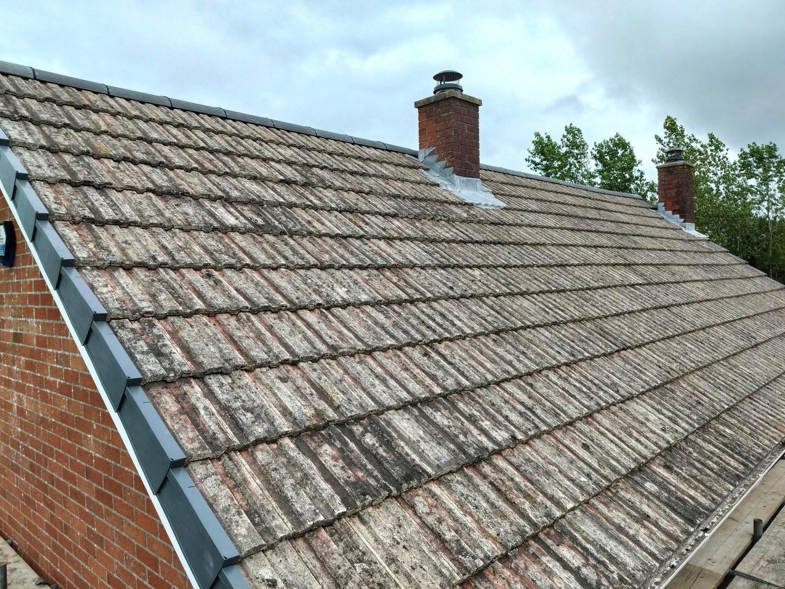Re-roofed tiled roof with new lead flashing around a brick chimney