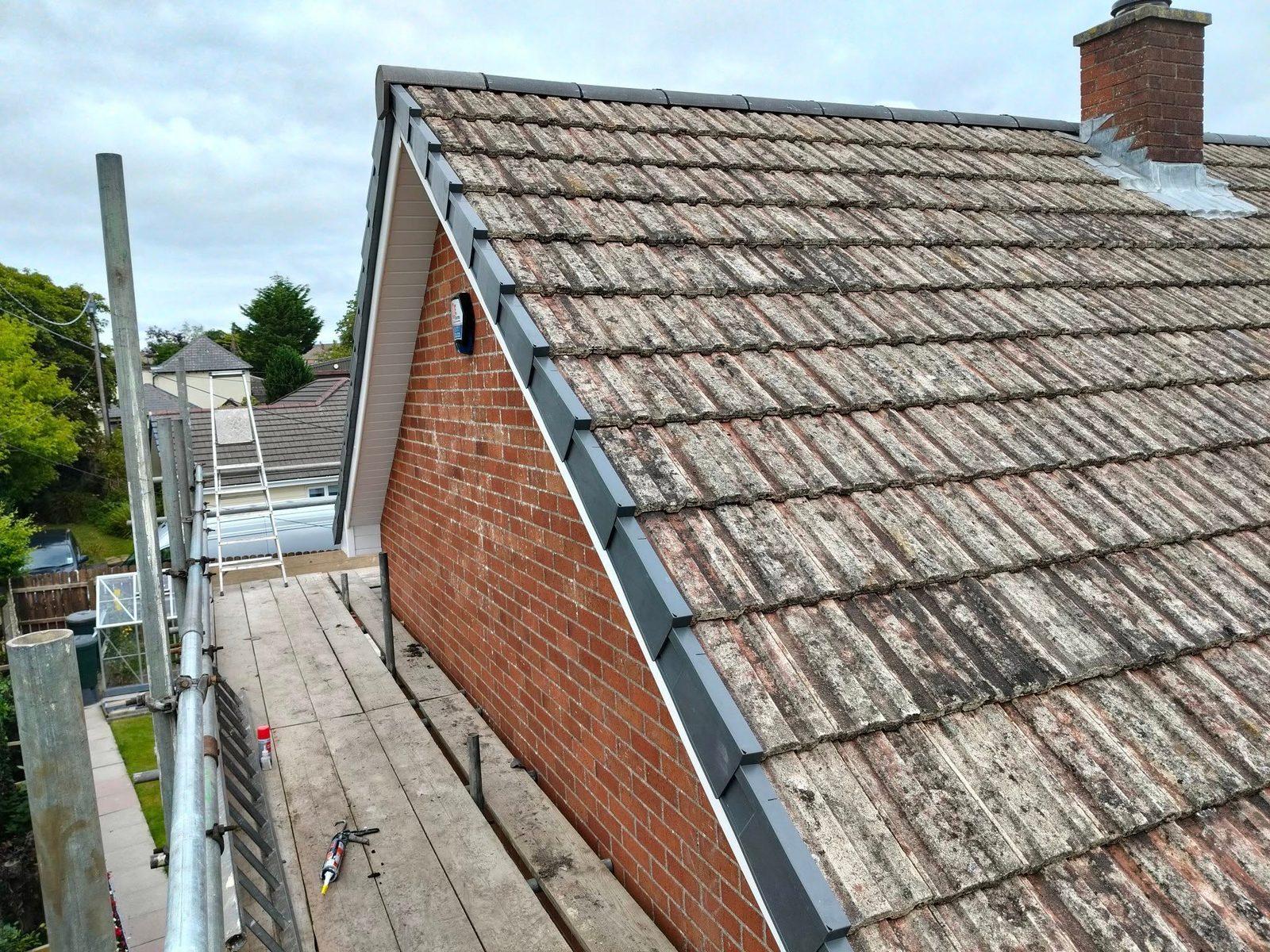 New anthracite verge trim and re-laid roof tiles