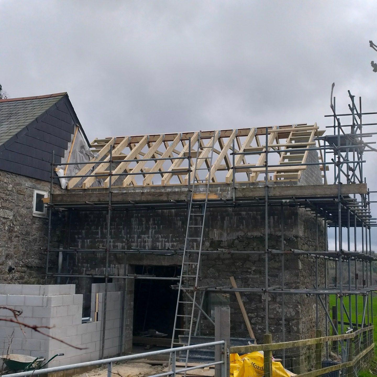 Stone barn conversion structural work with new roof timbers and scaffolding — during build